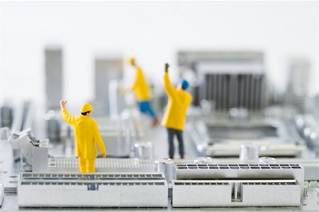 Miniature technicians standing on computer motherboard with arms raised Foto de stock - Sin royalties Premium, Código: 695-03390448