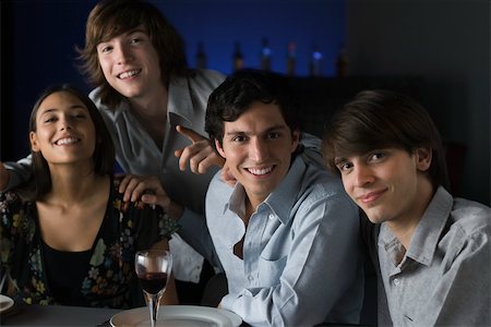 people standing behind a table - Friends in a bar, smiling at camera, portrait Stock Photo - Premium Royalty-Free, Code: 695-03390498