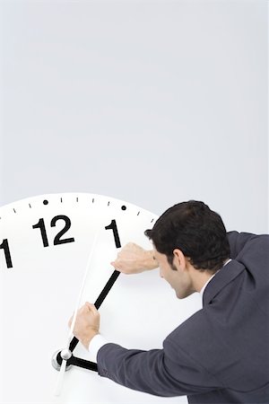 simsearch:695-03390555,k - Businessman trying to turn back hands of clock Foto de stock - Sin royalties Premium, Código: 695-03390535