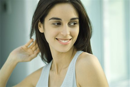 simsearch:695-05766280,k - Young woman, looking away, hand in hair, head and shoulders, portrait Stock Photo - Premium Royalty-Free, Code: 696-03394160