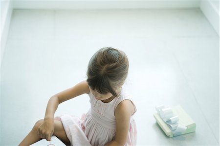 simsearch:632-01156362,k - Girl sitting on floor, opening presents Stock Photo - Premium Royalty-Free, Code: 696-03394245