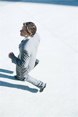 Young businessman walking outdoors, high angle view Stock Photo - Premium Royalty-Free, Code: 696-03394339