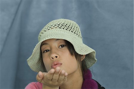 simsearch:696-03394580,k - Teenage girl looking at camera, blowing a kiss, portrait Stock Photo - Premium Royalty-Free, Code: 696-03394589