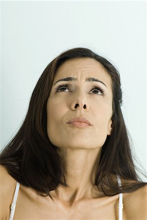 simsearch:695-05766896,k - Woman cringing, looking up, portrait Stock Photo - Premium Royalty-Free, Code: 696-03394615