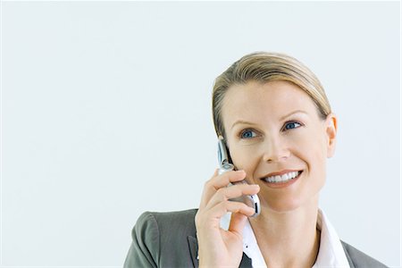 simsearch:695-03380514,k - Woman using cell phone, smiling, looking away Stock Photo - Premium Royalty-Free, Code: 696-03394634