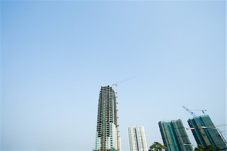 skyscraper construction - China, Guangdong Province, Guangzhou, high rises and cranes Stock Photo - Premium Royalty-Free, Code: 696-03394663