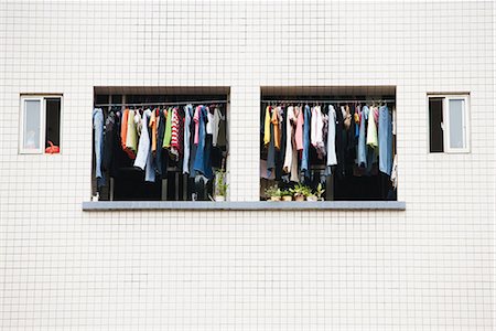 Laundry hanging to dry in balcony of apartment Stock Photo - Premium Royalty-Free, Code: 696-03394702
