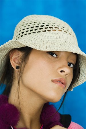 Teenage girl wearing hat, looking at camera, portrait Stock Photo - Premium Royalty-Free, Code: 696-03395003