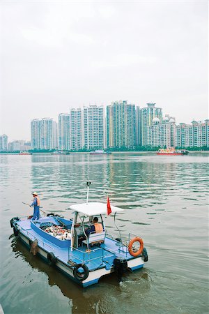 Garbage boat cleaning river Stock Photo - Premium Royalty-Free, Code: 696-03395076