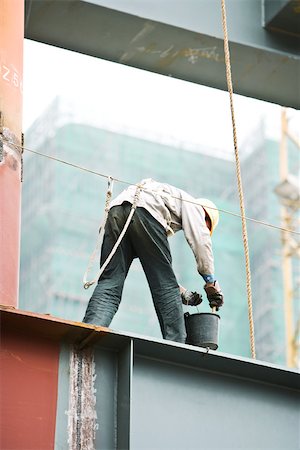 Construction worker working at construction site Stock Photo - Premium Royalty-Free, Code: 696-03395188