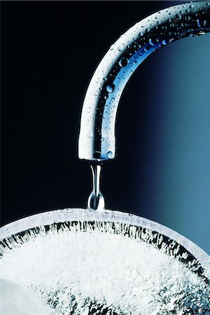 Water faucet dripping on ice, close-up Stock Photo - Premium Royalty-Free, Code: 696-03395290