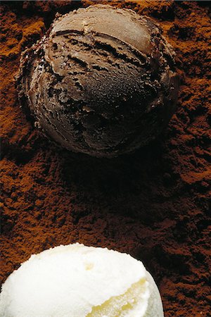 Two scoops of ice cream on cocoa powder, high angle view, close-up Stock Photo - Premium Royalty-Free, Code: 696-03395292