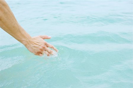 simsearch:696-03400450,k - Hand touching water, close-up Stock Photo - Premium Royalty-Free, Code: 696-03395434