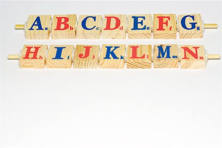 simsearch:628-02198065,k - Wooden alphabet blocks lined up, close-up Stock Photo - Premium Royalty-Free, Code: 696-03395697