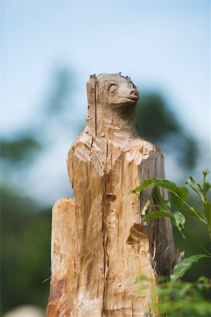 sculpted - Animal carved out of wood, foliage in foreground Stock Photo - Premium Royalty-Free, Code: 696-03395726