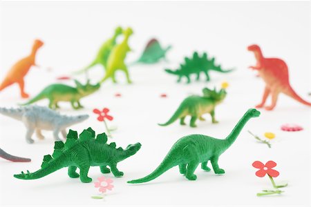 Plastic dinosaurs surrounded by fake flowers Stock Photo - Premium Royalty-Free, Code: 696-03395947