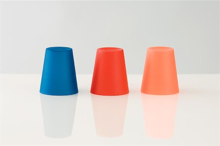 simsearch:696-03396044,k - Three colored cups, upside down Stock Photo - Premium Royalty-Free, Code: 696-03395961