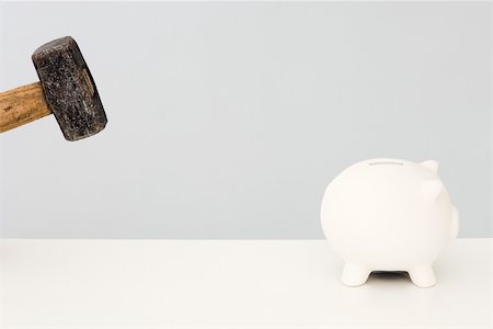 Piggy bank running away from hammer Stock Photo - Premium Royalty-Free, Code: 696-03395975
