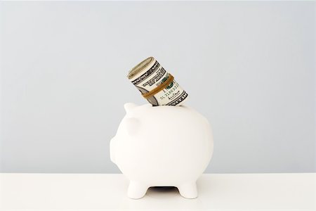 simsearch:696-03396044,k - Piggy bank with wad of money sticking out Stock Photo - Premium Royalty-Free, Code: 696-03395979