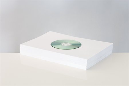 dvd - CD on top of stacked paper Stock Photo - Premium Royalty-Free, Code: 696-03395972