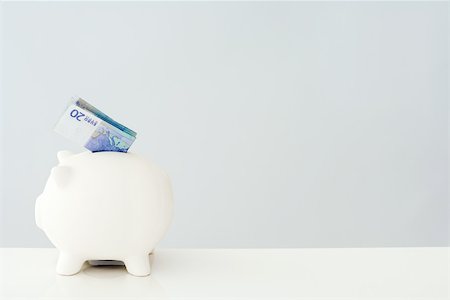 pig and profile - Folded twenty euro bill sticking out of piggy bank Stock Photo - Premium Royalty-Free, Code: 696-03396043