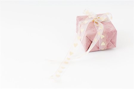 Wrapped gift with heart ribbon Stock Photo - Premium Royalty-Free, Code: 696-03396078