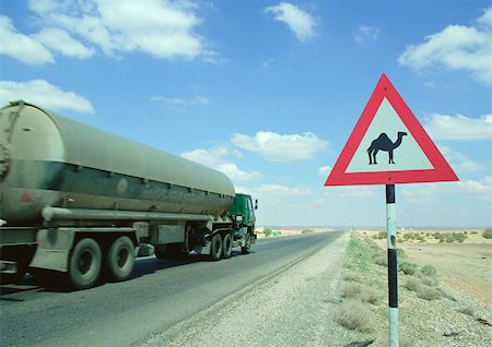 pictures of truck & blue sky and clouds - Jordan, tanker on road next to camel crossing sign Stock Photo - Premium Royalty-Free, Code: 696-03396267