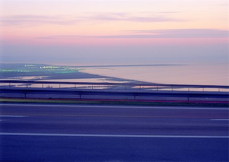 road panoramic blurred - Road and seascape at sunset Stock Photo - Premium Royalty-Free, Code: 696-03396277