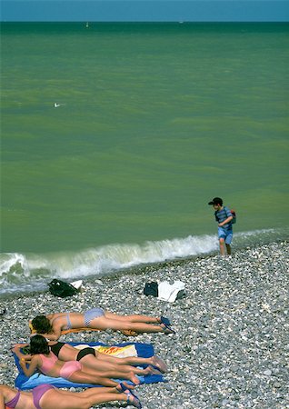 People lying on beach near sea Stock Photo - Premium Royalty-Free, Code: 696-03396867