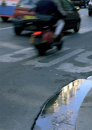 puddle road - Puddle on road with traffic Stock Photo - Premium Royalty-Free, Code: 696-03396875