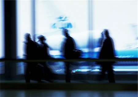 people airports silhouettes - People walking past windows, silhouette, defocused Stock Photo - Premium Royalty-Free, Code: 696-03396996
