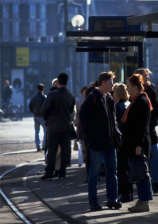 simsearch:696-03397048,k - Group of people standing near tracks on corner of the block Foto de stock - Sin royalties Premium, Código: 696-03397038