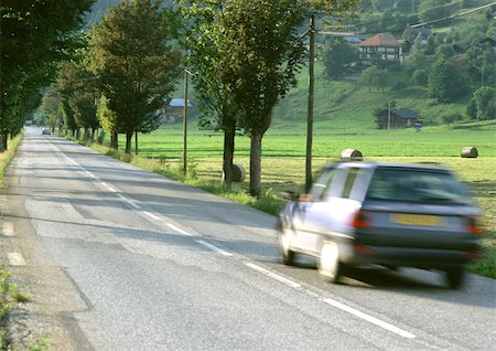 Fast moving car on road, blurred motion Stock Photo - Premium Royalty-Free, Code: 696-03397424