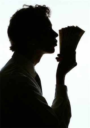 seven deadly sins - Man kissing money, silhouette. Stock Photo - Premium Royalty-Free, Code: 696-03397930