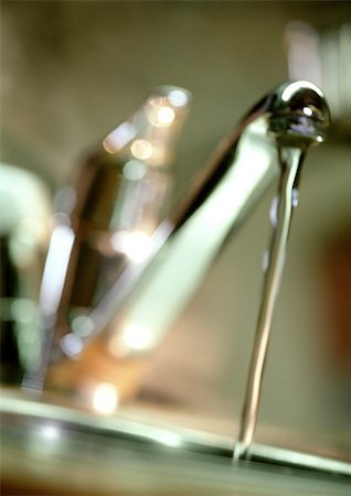 Water running from faucet, close-up, blurred Stock Photo - Premium Royalty-Free, Code: 696-03398153