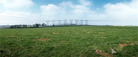 electricity towers images - Rural field with row of power lines in the distance, France Stock Photo - Premium Royalty-Free, Code: 696-03398495