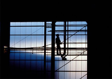 Silhouette of man standing on scaffolding Stock Photo - Premium Royalty-Free, Code: 696-03398556