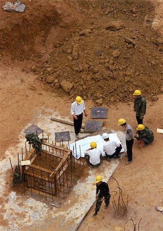 People wearing hard hats on construction site, elevated view Stock Photo - Premium Royalty-Free, Code: 696-03398610