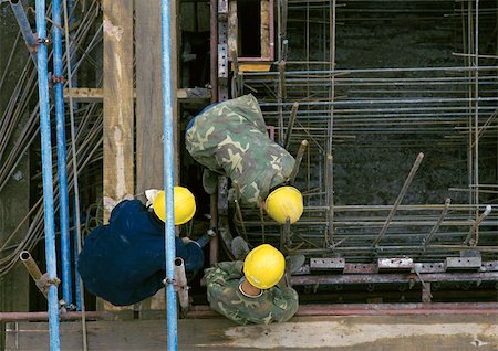 photo of civil engineering scaffolding - Three men wearing hard hats on construction site, elevated view Stock Photo - Premium Royalty-Free, Code: 696-03398633