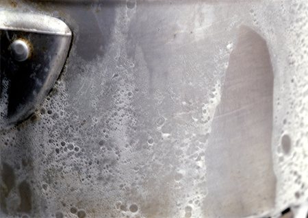 Milk boiling over saucepan, extreme close-up Stock Photo - Premium Royalty-Free, Code: 696-03398944