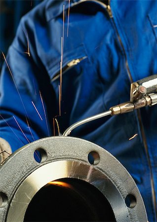 Person using welding torch, mid section Stock Photo - Premium Royalty-Free, Code: 696-03399025