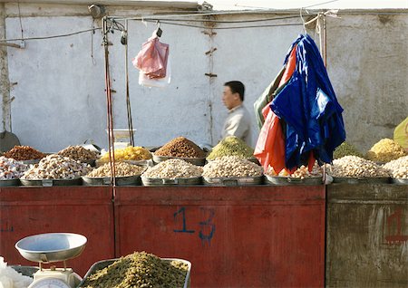 fruit in plastic bag - China, Xinjiang, Turpan, man behind stall in open air market Stock Photo - Premium Royalty-Free, Code: 696-03399243