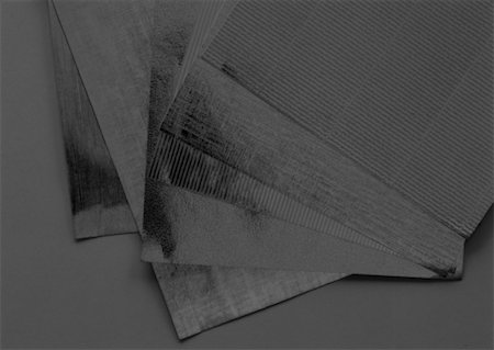 Sheets of paper, close-up, solarized Stock Photo - Premium Royalty-Free, Code: 696-03399297