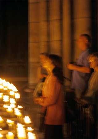 France, Paris, Notre Dame Cathedral, people standing by candles, blurred Stock Photo - Premium Royalty-Free, Code: 696-03399358