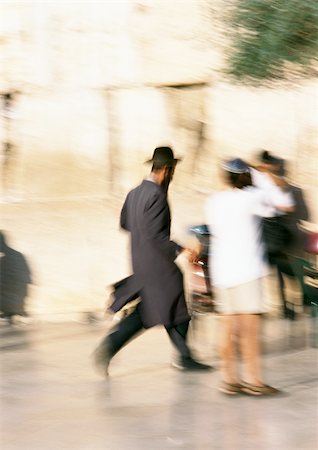 Israel, Jerusalem, Orthodox Jew running in street, blurred Stock Photo - Premium Royalty-Free, Code: 696-03399382