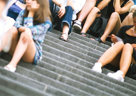 People sitting on stairs, low angle view Stock Photo - Premium Royalty-Free, Code: 696-03399510