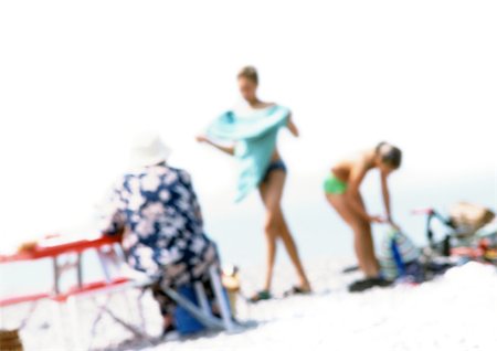 fat woman in bathing suit with man - Group of people on beach, blurred Stock Photo - Premium Royalty-Free, Code: 696-03399615