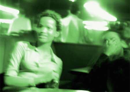 People in nightclub, blurred, green toned Stock Photo - Premium Royalty-Free, Code: 696-03399653
