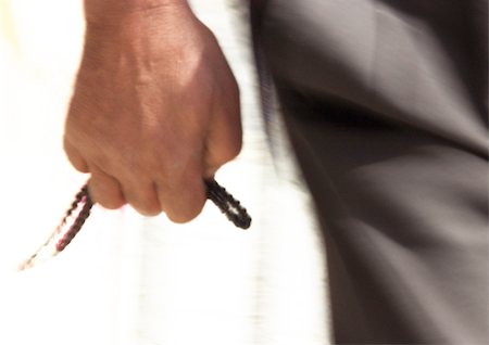 Close up of man's hand holding prayer beads Stock Photo - Premium Royalty-Free, Code: 696-03399776