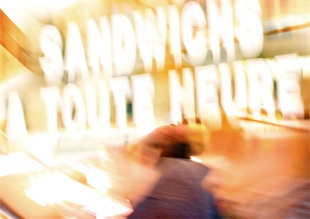 food shop windows - Sign saying "sandwiches served all day" in French, blurred Stock Photo - Premium Royalty-Free, Code: 696-03399951